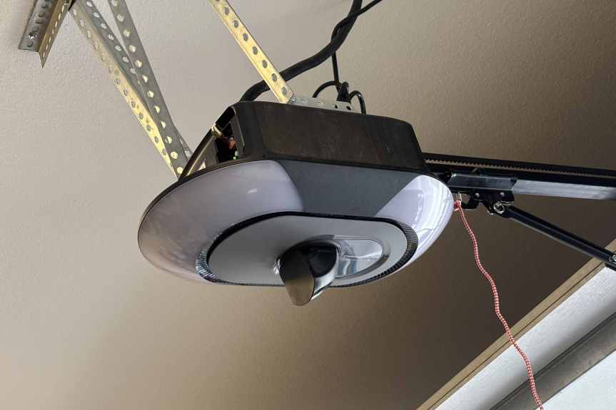 A Chamberlain smart garage motor on a garage ceiling.