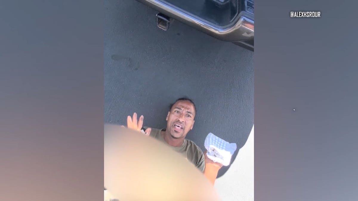 Juan Antonio Gonzaba on the ground after being chased by citizens who witnessed him drive a car through a crowded pedestrian walkway.