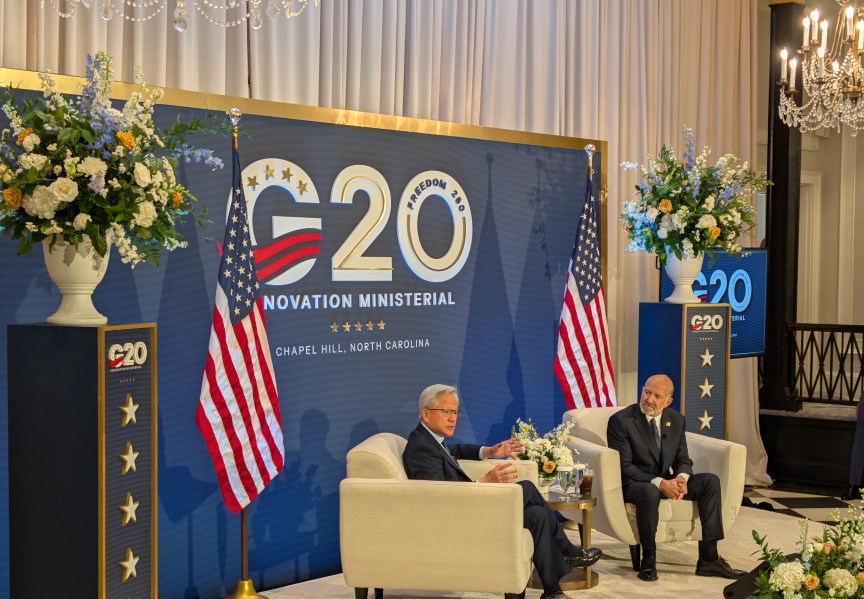 Jensen Huang on stage with Howard Lutnick at the G20 forum