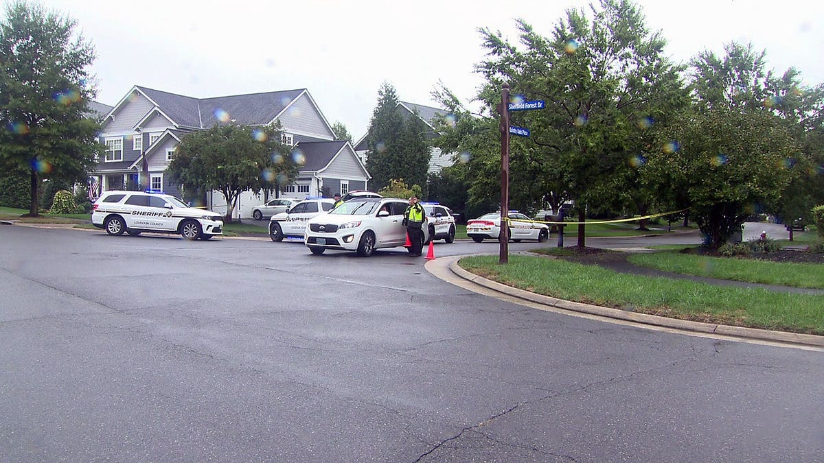 Loudoun County Sheriff's Office vehicles and deputies at the scene of a fatal shooting in Aldie, Virginia.