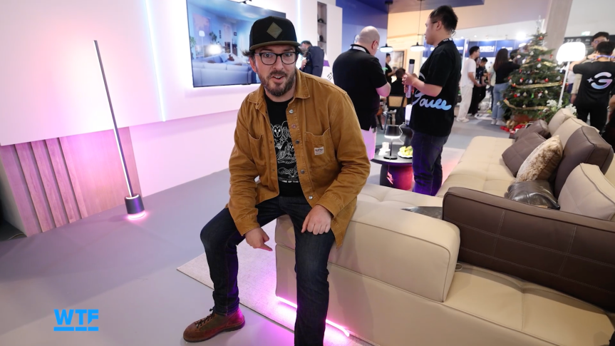 The writer sitting on a couch that has lighting on the underside at IFA.