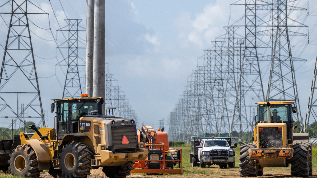 Service technicians work to install the foundation for a transmission tower at the CenterPoint Energy power plant on June 10, 2022 in Houston, Texas.