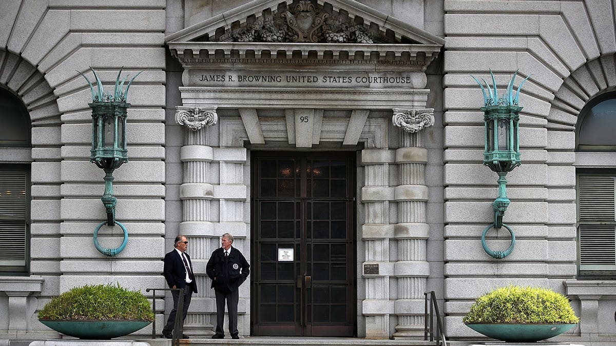 Security guards stand in front of the Ninth U.S. Circuit Court of Appeals building in San Francisco.