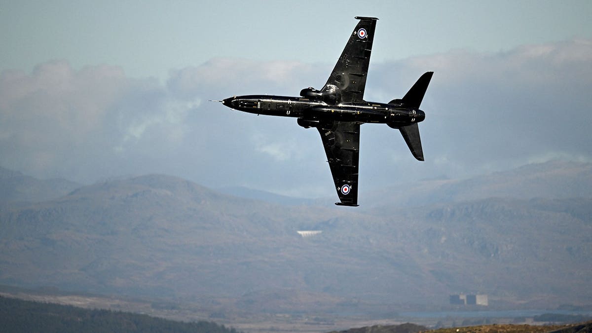 RAF Hawk T2 aircraft flies low through a valley in north Wales